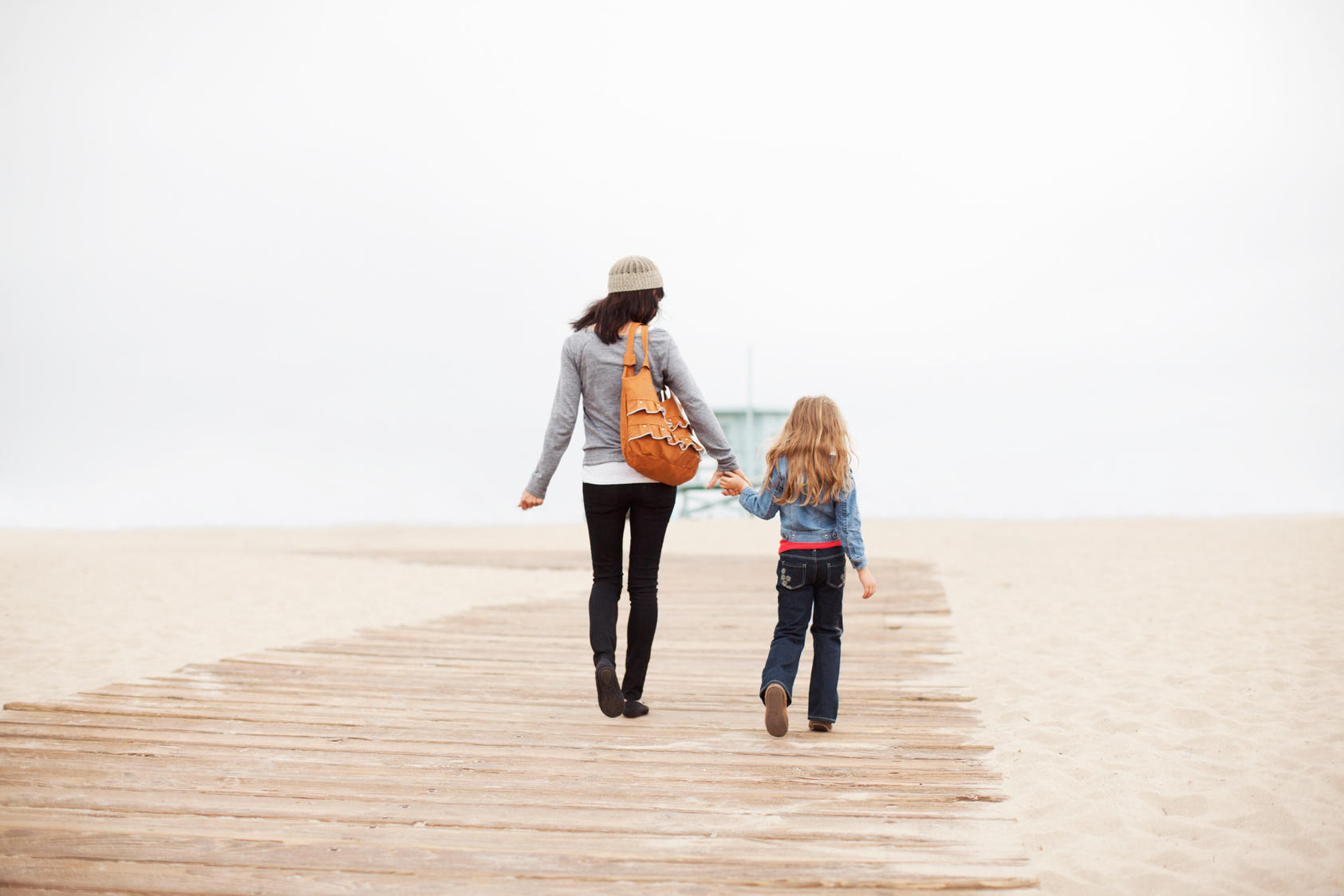 Mom and Daughter Walking Along Beach